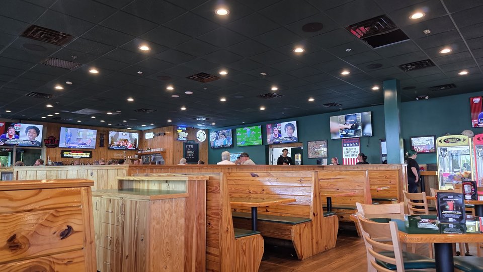 Casual dining room with sports-bar seating.